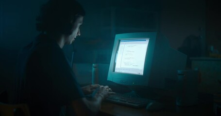 Fototapete - Caucasian Male Web Designer Using Old Desktop Computer In Retro Garage Late At Night. Focused Internet Enthusiast Writing Code At Home. Programming Successful Social Network Website In Nineties.