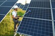 © Serhii - Indian man in uniform working near solar panel.