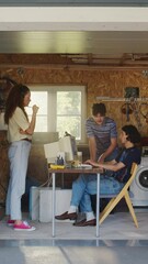 Poster - Vertical Screen: Diverse Team Of Three Young Tech Startup Company Founders Working In Retro Garage, Using Old Desktop Computer. Male And Female Entrepreneurs Developing Online Service In Nineties.