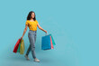 © Prostock-studio - Positive young indian woman shopaholic walking with purchases