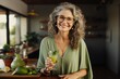 © Creative Clicks - A cheerful elderly woman grinning as she holds a glass of fresh green juice.