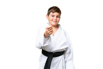 Wall Mural - Little caucasian kid doing karate over isolated chroma key background making money gesture