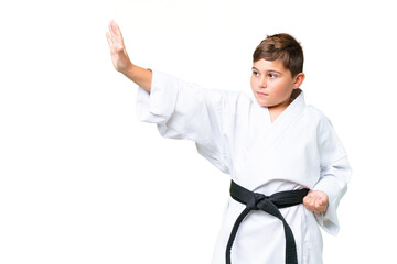 Wall Mural - Little caucasian kid over isolated chroma key background doing karate