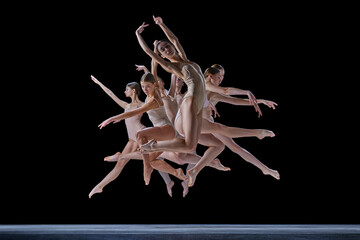 Expressive, artistic dance. Ground of young tented people, ballet dancers in motion, dancing against black background. Concept of classical and modern dance, beauty, creativity, art, theater