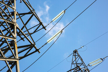 Wall Mural - High voltage tower with electrical voltage wires isolates close-up against the background of clouds. Energy industry.