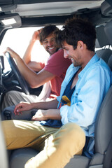 Driving, travel and happy men friends in a van for road trip, adventure or vacation together. Freedom, transportation and people relax, joke or laughing in a vehicle for holiday, trip or journey