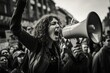 a woman shouting through megaphone on a workers environmental protest in a crowd in a big city. black and white documentary photo