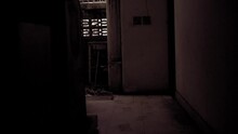 Halloween Abandoned Bathroom Or Bathroom Asylum. Looking Down Abandoned Hallway With Hanging Flickering Light And Ghostly Window Glow.