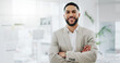 © Clement C/peopleimages.com - Business man, portrait and smile with arms crossed in an office for confidence and career pride. Professional entrepreneur person from Morocco at corporate company with positive attitude and space