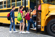 © Prostock-studio - Group of happy excited children boarding yellow school bus