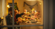 © Gorodenkoff - Happy Family Gather at Home for a Traditional Christmas Dinner with a Turkey Roast. Living Room is Crowded with Senior and Young Adults Enjoying Holiday Dishes. Creative Shot Through a Snowy Window