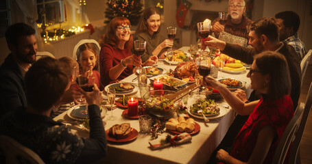 Wall Mural - Christmas Celebration at Home with Multicultural Group of Loved Ones Enjoying a Turkey Dinner. Festive Atmosphere Fills the Room while Family Raising Glasses, Toasting, Celebrating Winter Holiday