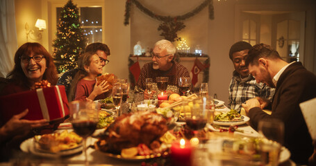 Wall Mural - Big Diverse Family Exchanging Christmas Gifts to Celebrate the Holiday. Beautiful Old and Young Relatives Excited to Receive Presents. Christmas Dinner Together with Parents and Children at Home