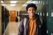 Smiling Portrait of a young male student in a school hallway