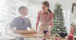 Portrait of Mother and Son Baking Together During Christmas. Cute Little Boy and his Mom Preparing Dough and Making Gingerbread Cookies. Happy Childhood Memories of Holidays