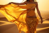 a close-up portrait of a beautiful gorgeous arabian oriental bellydancer in golden yellow flowy costume dancing traditional style of bellydance in the desert