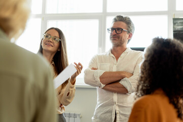 Group of confident businesspeople working in modern office talking, brainstorming, planning strategy