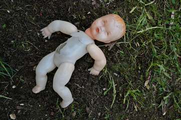 old broken plastic doll