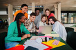 © Jose Calsina - Big group of multiracial teenage students using laptop, working on university assignment homework project on high school library. Teamwork of diverse young colleagues searching information on computer