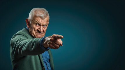 Canvas Print - Senior man pointing with hand and finger to the side looking at the camera.