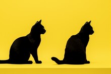 Silhouettes Of Black And White Cats Stretched Out On A Yellow Background. Generative AI