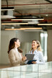 © BGStock72 - Two young business women with digital tablet in the office hallway