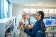 © Marko Geber - Diverse pair of senior female friends browsing the shelfs of a drugstore
