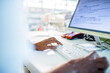 © Marko Geber - Close up of a senior woman working on the the laptop at the drugstore