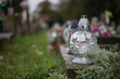 Close up of Votive candles lantern on the grave in Slovak Catholic cemetery during day. Autumn scene. All Hallows eve. Memorial to the deceased. Solemnity of All Saints. 1st November, All Saints' Day