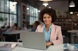 © pham - A woman working on her laptop at a table