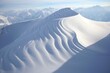 Helicopter view of a crescent-shaped ridge on a mountain during winter