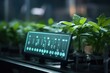 © gankevstock - Tablet with blue screen displaying icons and graphs in a greenhouse with plants. future growing technologies