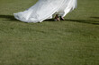 Beautiful bride wearing a white wedding dress running away
