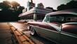 A classic car standing on an asphalt road next to a retro restaurant.