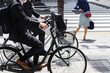 Japanese business men on bicycles on the sidewalk in Tokyo