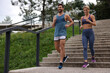 © New Africa - Healthy lifestyle. Happy couple running down stairs outdoors