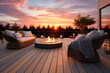 Modern living deck furnished with open gas fire in background of beautiful sunset. Relaxation concept of buildings and spaces.