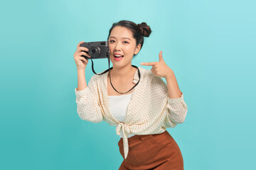 Full isolated studio picture from a young and beautiful woman with retro camera