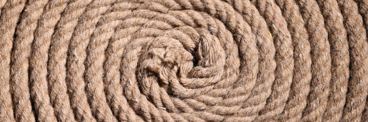 Wall Mural - Coil of twisted strong brown rope as background texture