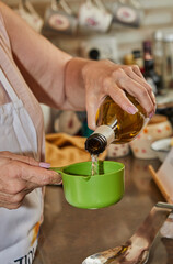 Poster - Chef pours white wine into measuring cup