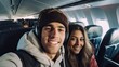 © Kowit - Happy tourist taking selfie inside airplane - Cheerful couple on summer vacation - Passengers boarding on plane - Holidays and transportation concept