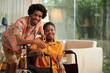 © DragonImages - Portrait of smiling Black man and his girlfriend with disability spending time at home together