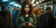 Young woman is using a mobile phone in the metro