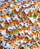 Fototapeta Dinusie - A whimsical Christmas village with colorful houses