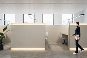 Canvas Print - Happy young businesswoman walking in modern coworking office interior with empty mock up place, partitions and workplaces, window with city view and daylight.