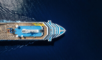 Wall Mural - Aerial top down view of a cruise ship bow traveling over blue ocean