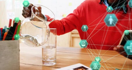 Canvas Print - Animation of icons globes, african american man holding cellphone and pouring water in glass