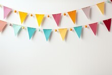 Colorful Holiday Flags In The Form Of A Garland On The Wall. The Garland Hangs In Two Rows. Congratulatory Background With Place For Text. Holiday Concept
