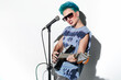 © ADDICTIVE STOCK - Energetic female rock star playing guitar in bright studio over white background