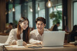 © Kust - Asian guy and girl are drinking coffee and working on a laptop. Work process, communication, ai